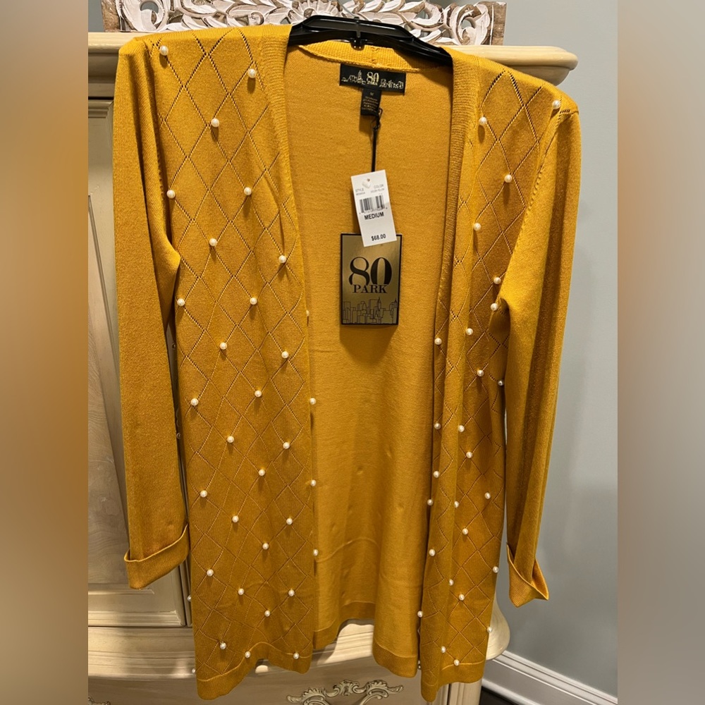 Brand-new never worn lightweight cardigan adorned with pearls.